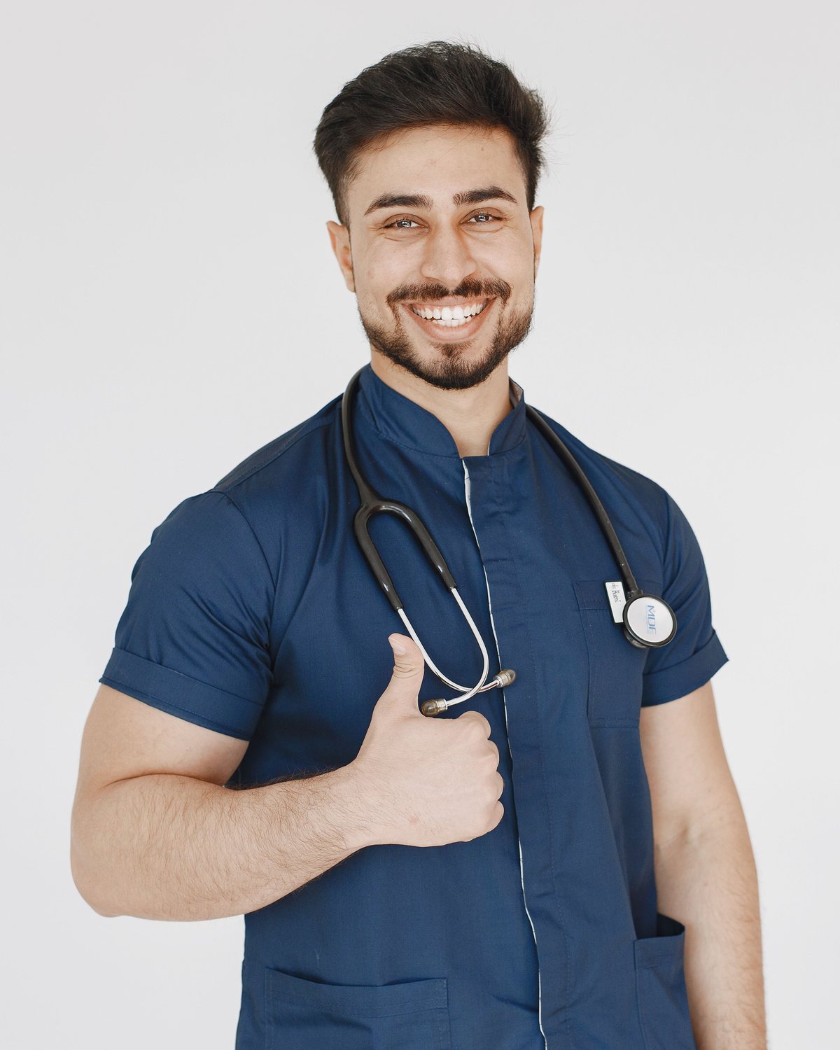 Friendly doctor in scrubs smiling and welcoming new patients